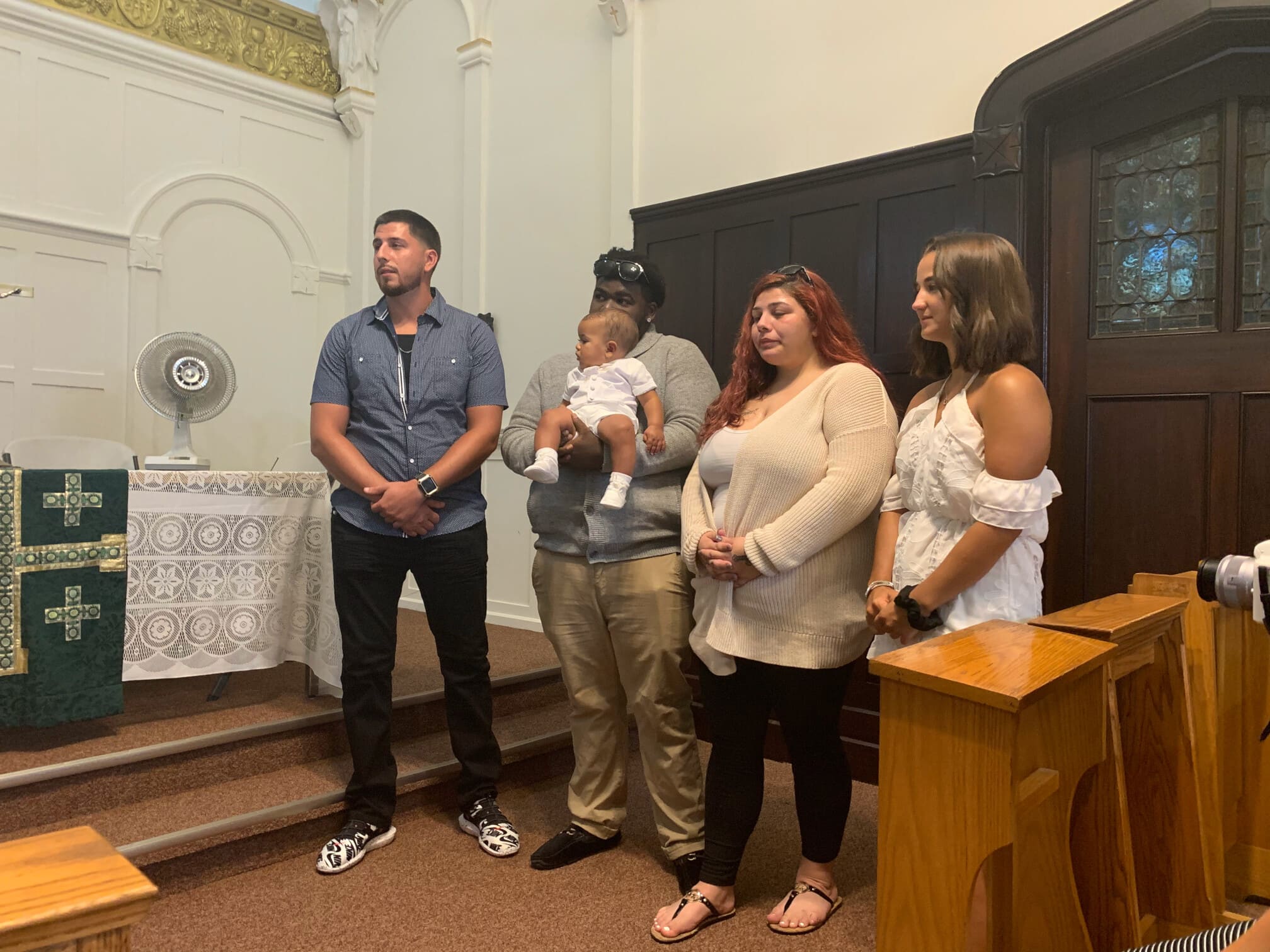 Lexi, middle, with her boyfriend Tyrelle and their son Jayceon at his baptism in the chapel of Mercy House in Newark. Pictured far left is Lexi's brother, Robert (godfather), and far right is Lexi's cousin, Madison (godmother).