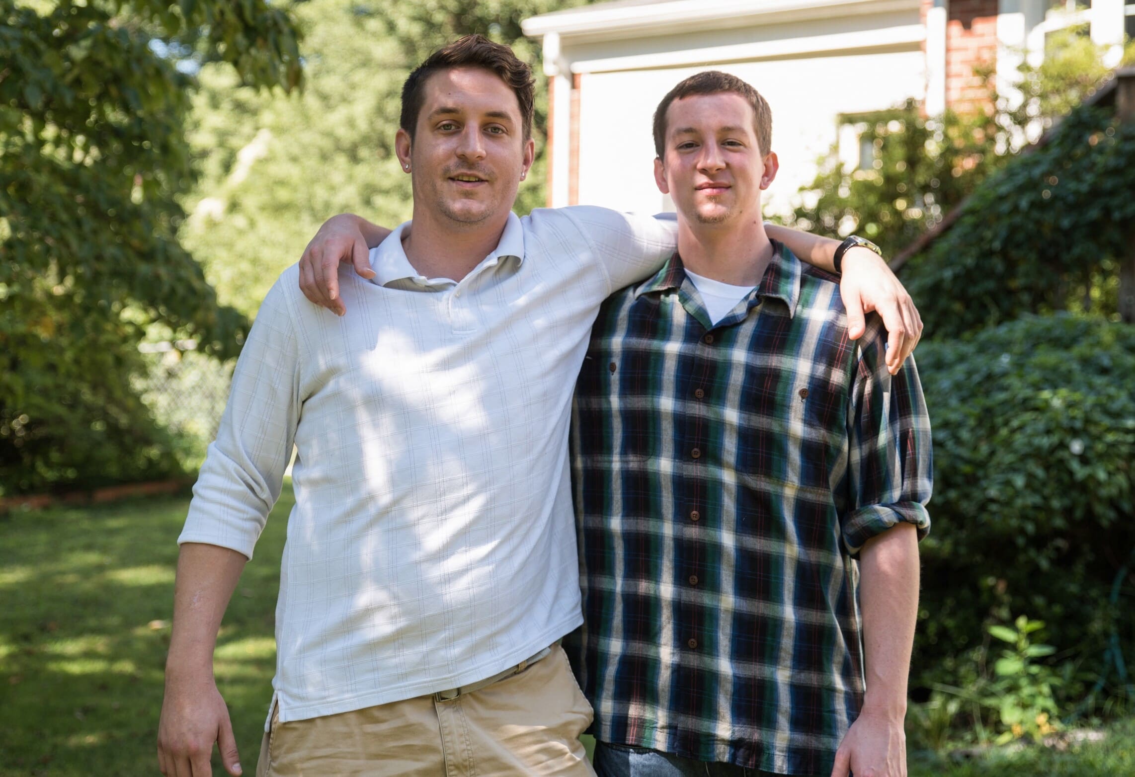 Recovering addicts Brian Peck and Dan Buckley stand in the backyard of the sober living home Sept. 6 in Annandale, Va., where they currently live. (CNS photo/Zoey Maraist, The Catholic Herald) See OPIOID-ADDICTION Sept. 14, 2018.