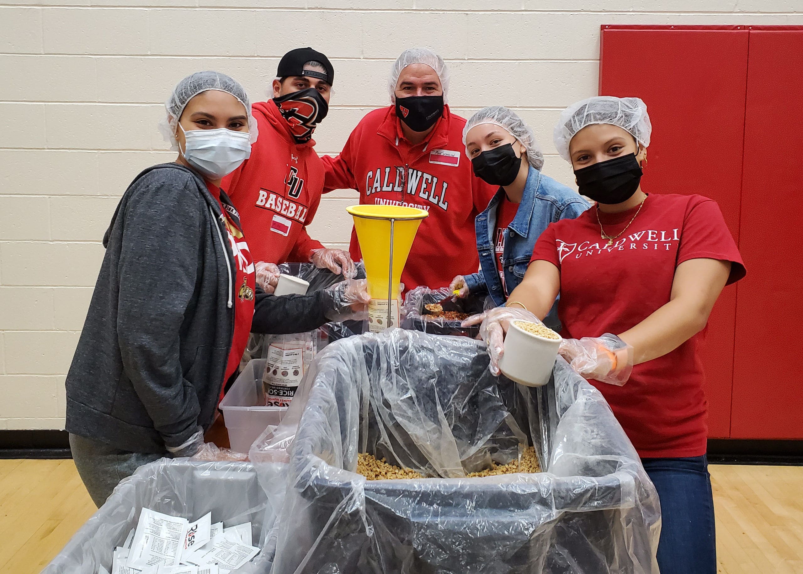 Featured image: Caldwell University President Matthew Whelan, Ed.D. and students packaging meals for Rise Against Hunger for Caldwell Service Day. (Courtesy of Caldwell University)