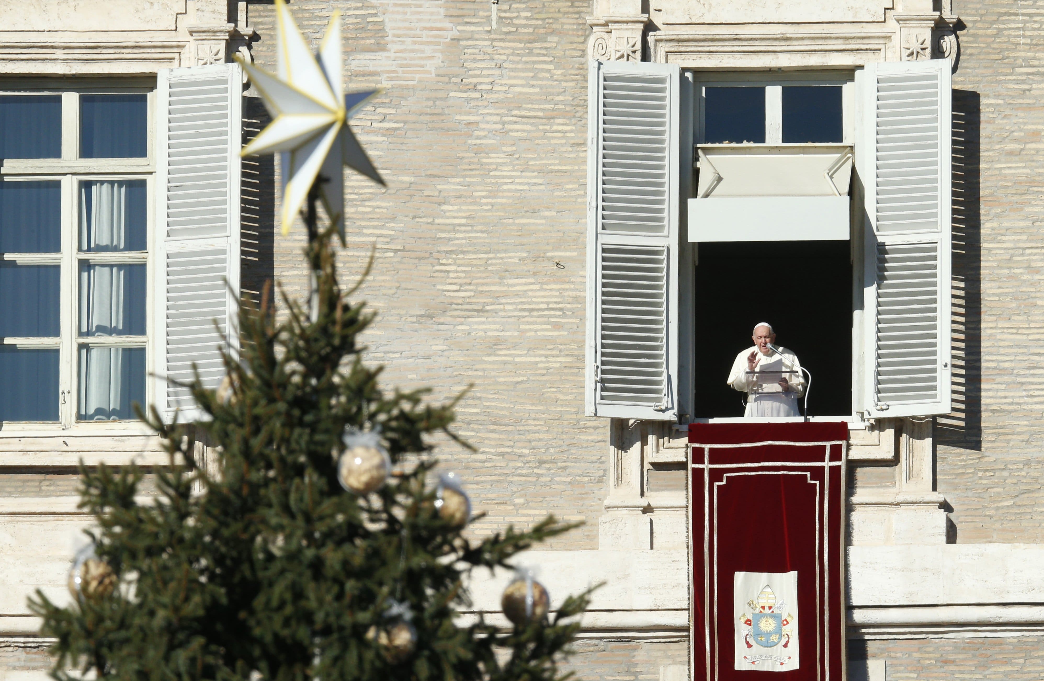 The Christmas tree is seen as Pope Francis leads the Angelus from the window of his studio overlooking St. Peter's Square at the Vatican Dec. 19, 2021. (CNS photo/Paul Haring)