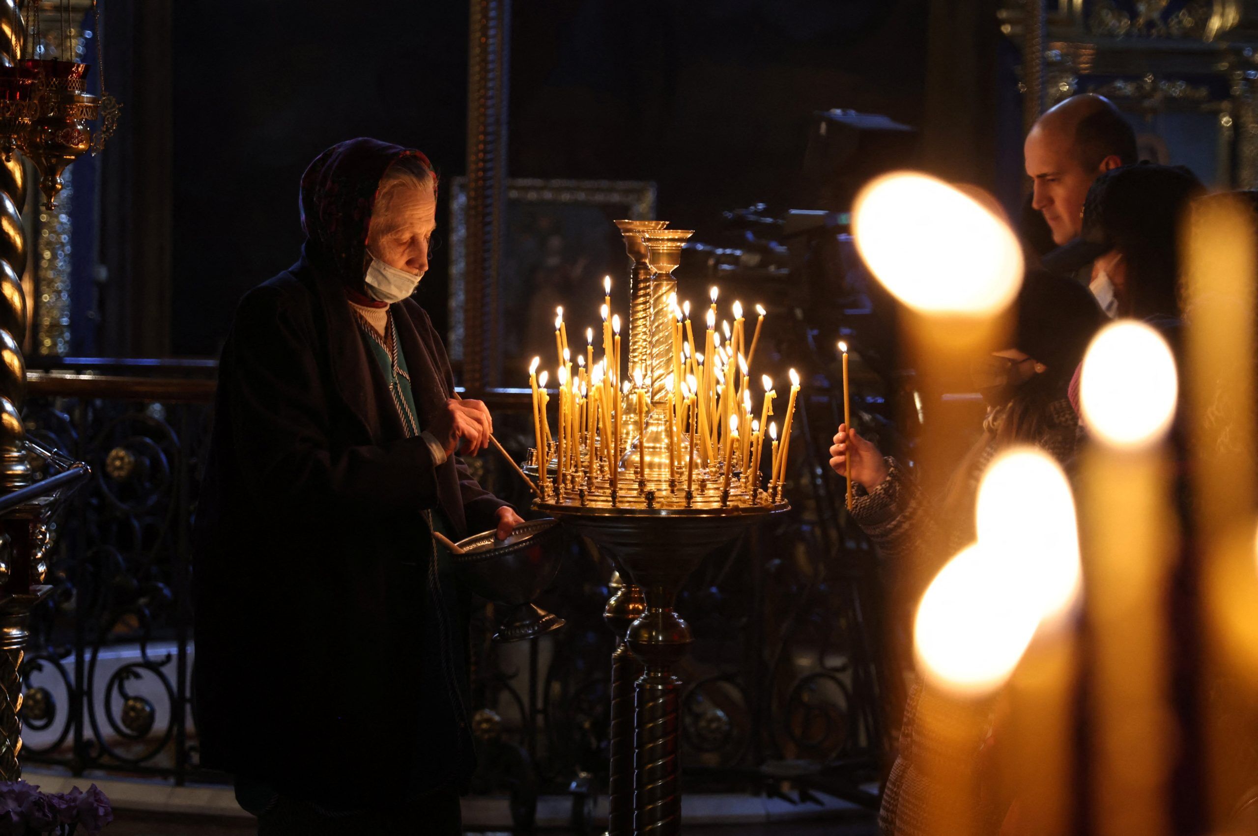 Worshippers light candles as they attend a prayer service at St. Michael's Cathedral of the Orthodox Church of Ukraine in Kyiv Feb. 20, 2022. Pope Francis expressed "great sorrow" over the situation in Ukraine and called on Christians to observe a day of prayer and fasting for peace on Ash Wednesday, March 2. (CNS photo/Umit Bektas, Reuters)