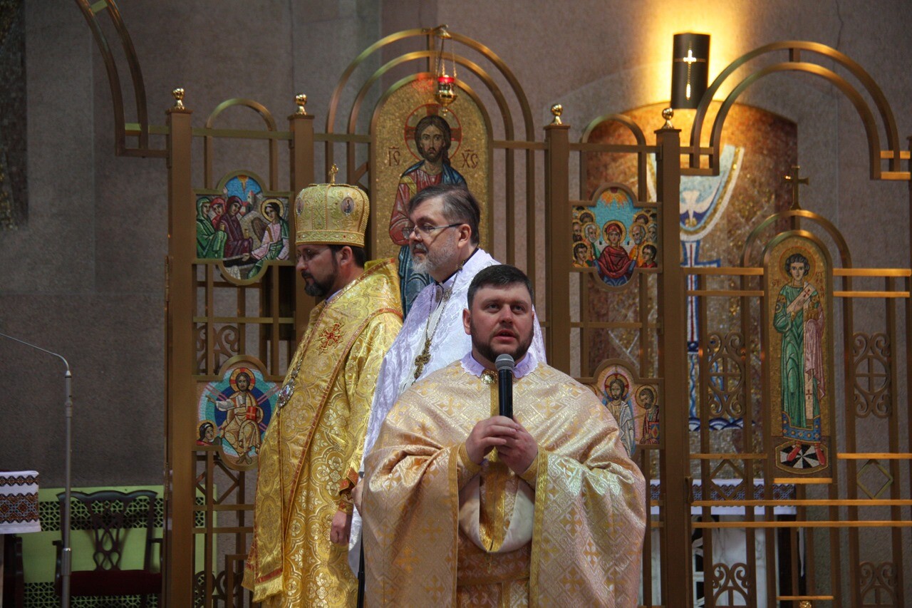Father Taras Svirchuk, C.Ss.R., is pictured holding a microphone at St. John The Baptist Ukrainian Catholic Church in Newark where he is pastor. (Courtesy of Father Taras Svirchuk, C.S