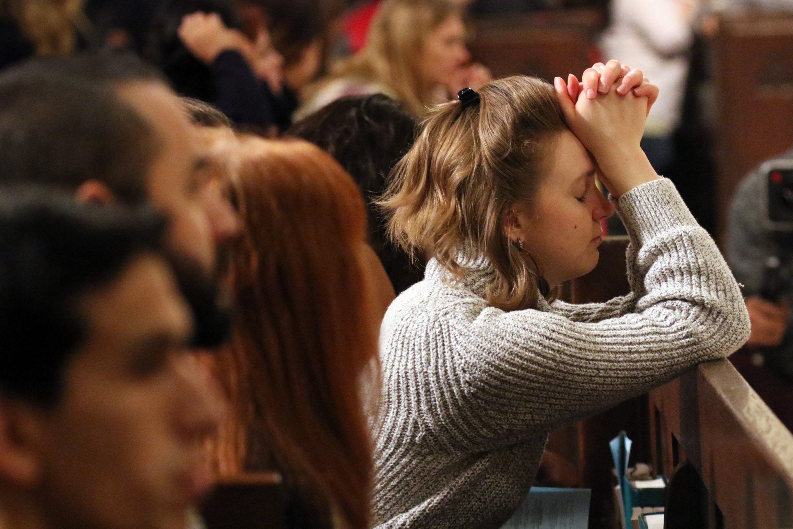 A woman prays prior to a Mass for young adults Dec. 7, 2016, at St. Patrick's Cathedral in New York City. (CNS photo/Gregory A. Shemitz)