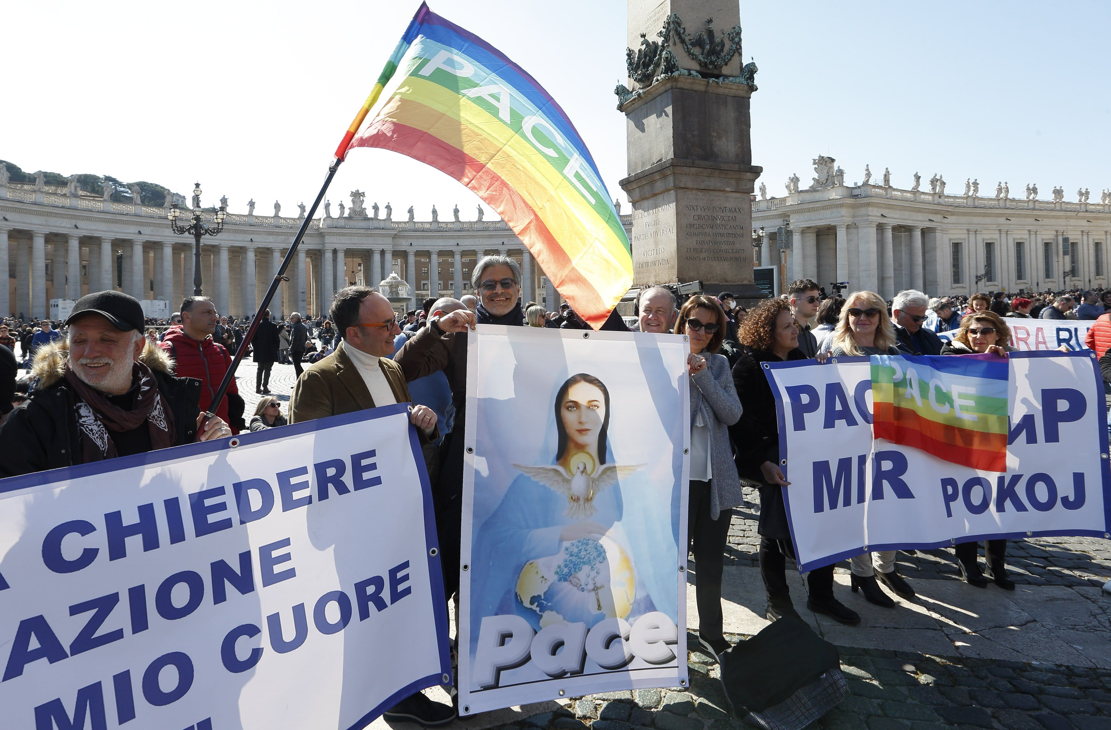 People in St. Peter's Square hold an image of Mary and peace flags before Pope Francis' recitation of the Angelus at the Vatican March 13, 2022. The Vatican said Pope Francis will consecrate Russia and Ukraine to the Immaculate Heart of Mary March 25. (CNS photo/Paul Haring)