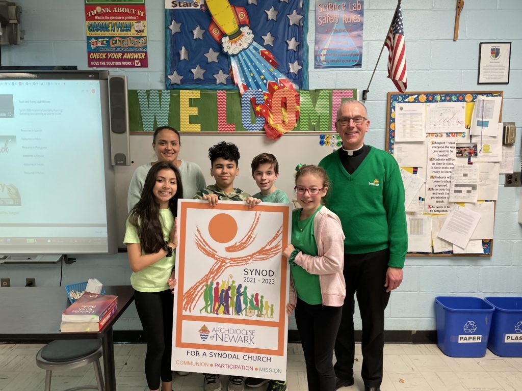 Father John Job, the pastor of Church of the Most Blessed Sacrament in Franklin Lakes, N.J., is pictured with students in Mrs. Ramdath’s sixth grade class at The Academy of the Most Blessed Sacrament who recently participated in a synod listening session. (Photo courtesy of Father John Job)