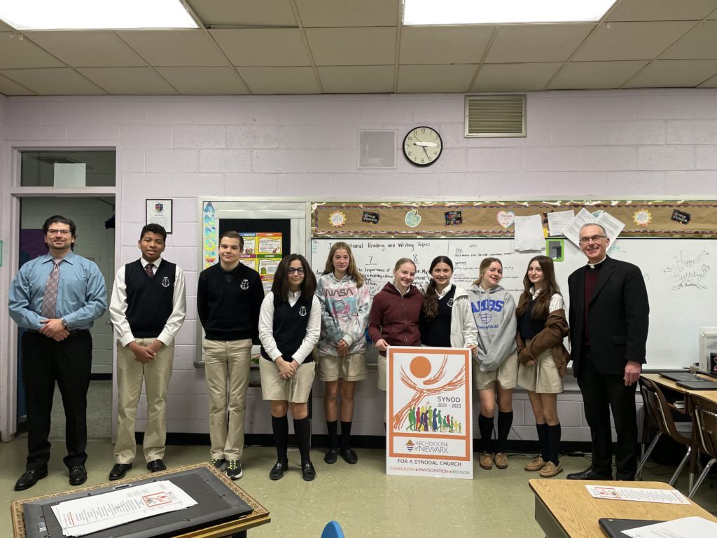 Father John Job, the pastor of Church of the Most Blessed Sacrament in Franklin Lakes, N.J., is pictured with students in Mr. Quintilian’s eighth grade class at The Academy of the Most Blessed Sacrament who recently participated in a synod listening session. (Photo courtesy of Father John Job)
