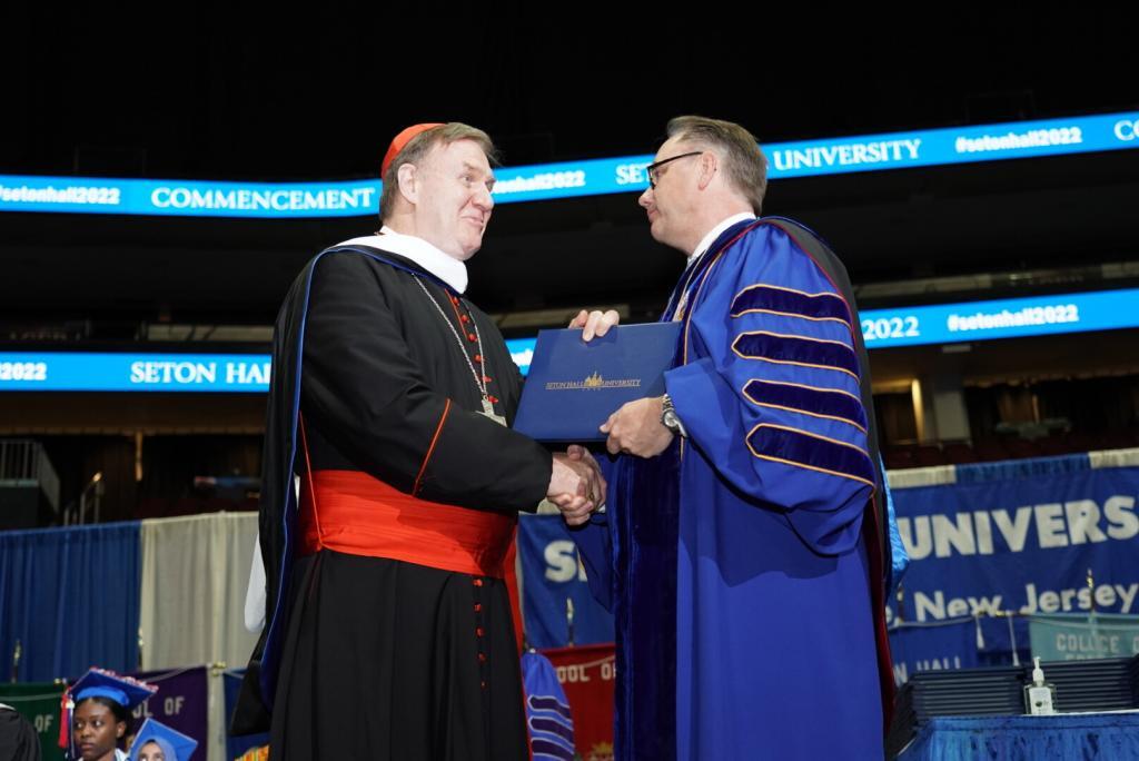 Cardinal Joseph W. Tobin, C.Ss.R., receives an honorary Seton Hall University degree from President Joseph E. Nyre on May 24, 2022.