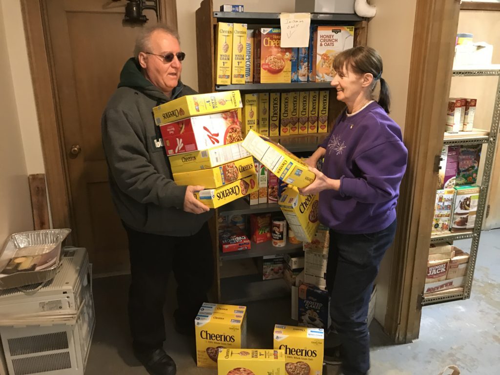 Bill and Marianne Mackey are pictured in the food pantry at Queen of Peace Church in North Arlington where the Mackeys serve and worship. (Photo by Jai Agnish/Archdiocese of Newark)