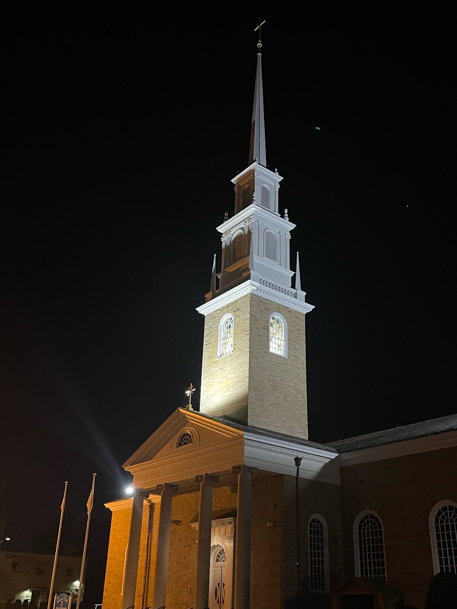 Queen of Peace Church’s newly refurbished steeple lit up the night sky during a rededication ceremony on November 26, 2022, the latest event in the North Arlington parish’s yearlong centennial anniversary celebration.