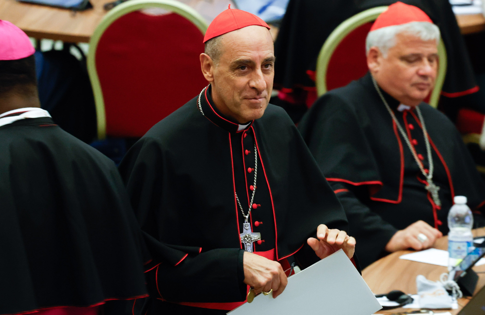 Cardinal Víctor Manuel Fernández, prefect of the Dicastery for the Doctrine of the Faith, discussing the matter of women deacons with synod members.