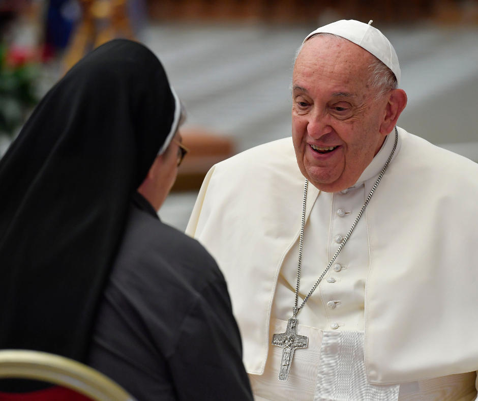 Pope Francis greets a participant at the Synod of Bishops on synodality before the working session begins Oct. 8, 2024, in the Paul VI Audience Hall at the Vatican. (CNS photo/Vatican Media)