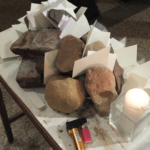 The names of potential deportees, placed on a table, are lifted up in prayer.