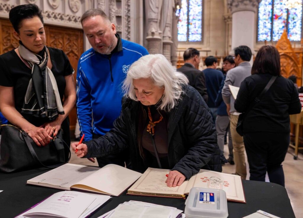 A catechumen signs the Book of the Elect at the Rite of Election on Sunday, March 9, 2025