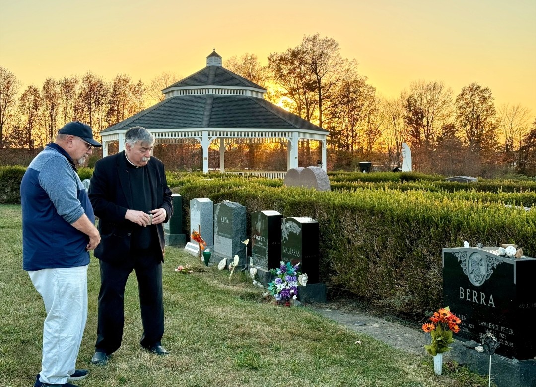 Larry Berra and Father Gabriel Costa at Yogi Berra gravesite