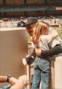 Yogi Berra hugs his granddaughter Lindsay at Yankee Stadium in 1984