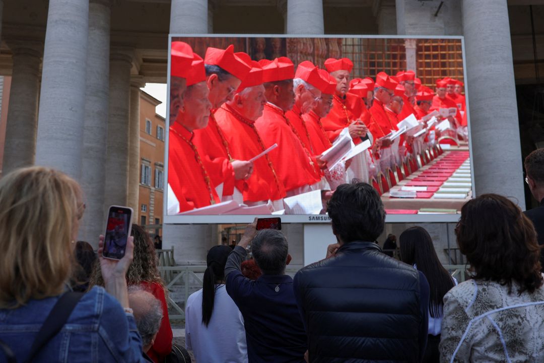 Crowd gathers in St Peters Square to watch beginning of conclave