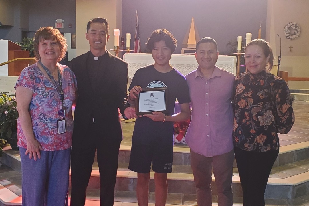 Mikalle, grand-prize winner of the 2025 Cardinal Joseph Tobin Award for Priestly Vocations Essay and Video Contest, with his parents, parish priest, and mentor.