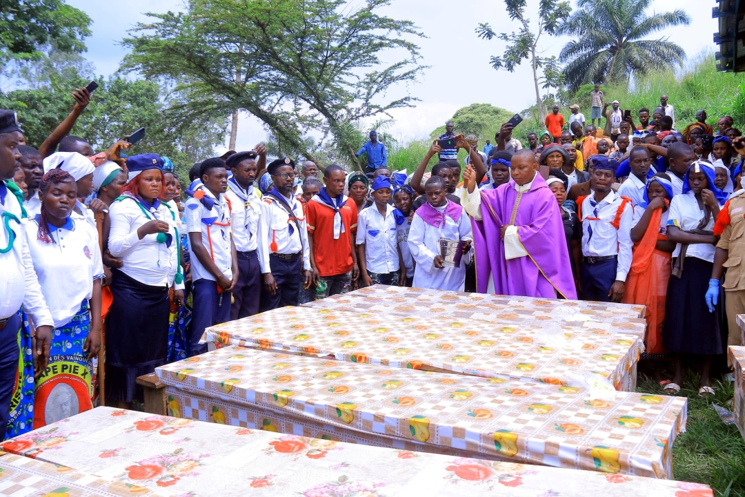 Congo church massacre - Priest blesses coffins