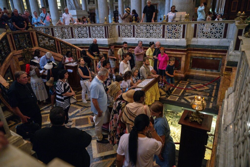 Pilgrims pray at tomb of St Paul in the Basilica of St Paul Outside the Walls