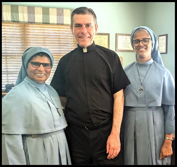 Monsignor Fuhrman with Daughters of Mary, India
