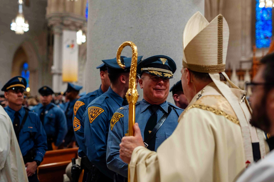 BM - Cardinal greets police officer