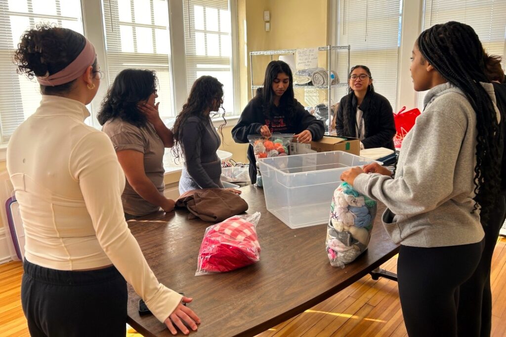 The Mercy House - Volunteers organizing giveaway items