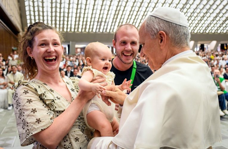 Pope Francis greets baby and parents at audience Aug 2025