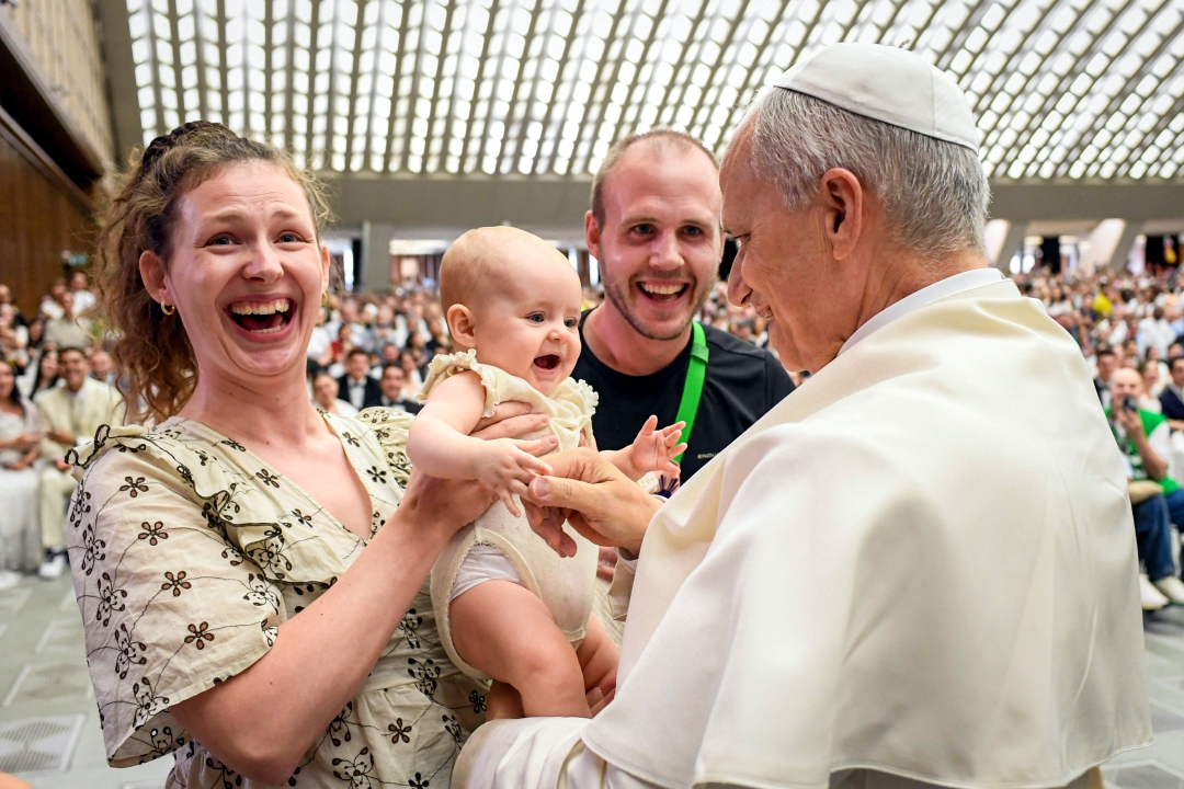 Pope Francis greets baby and parents at audience Aug 2025