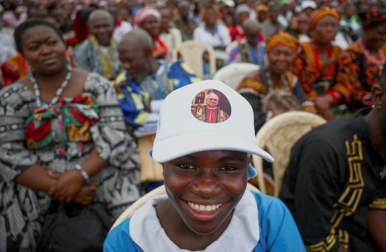 PLVC - Young woman wears Pope Leo hat Cameroon Mass