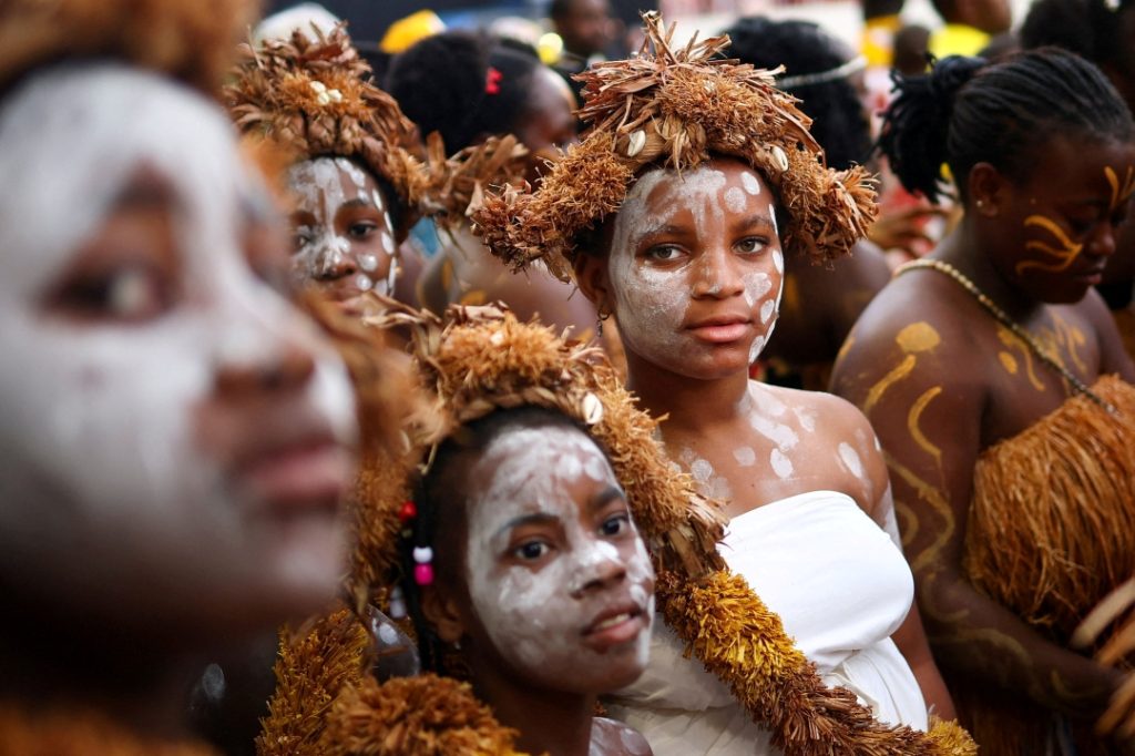 PTEG - People wearing traditional clothing wait for Pope Leo XIV's arrival