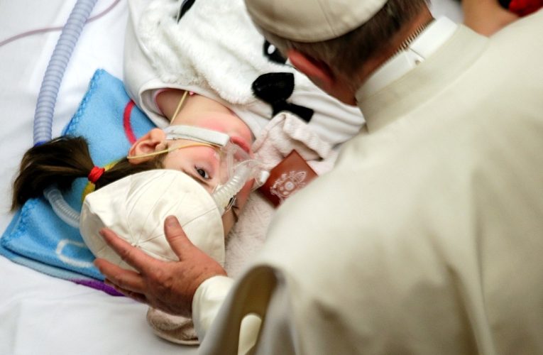 Pope Francis visits with child at Bambino Gesu