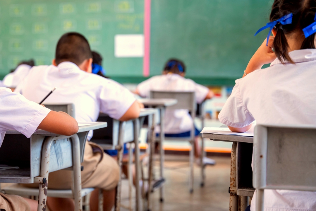 Students in uniform in class - stock