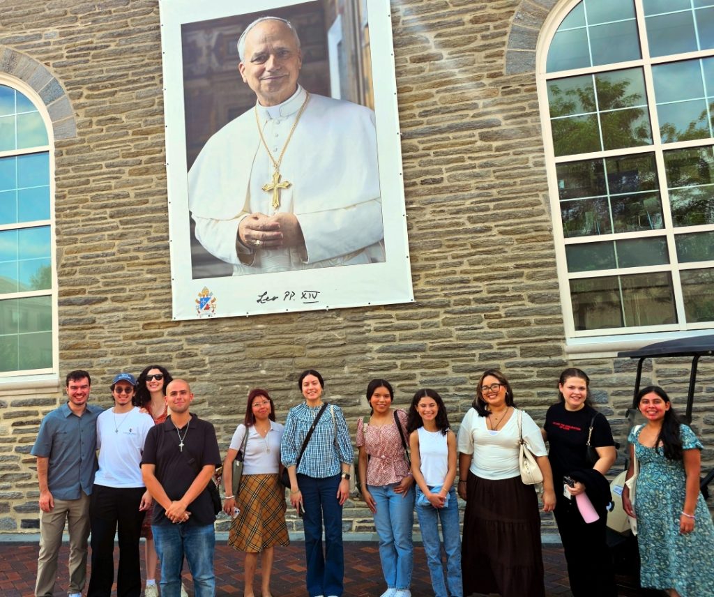 Kean students in front of photo of Pope Leo